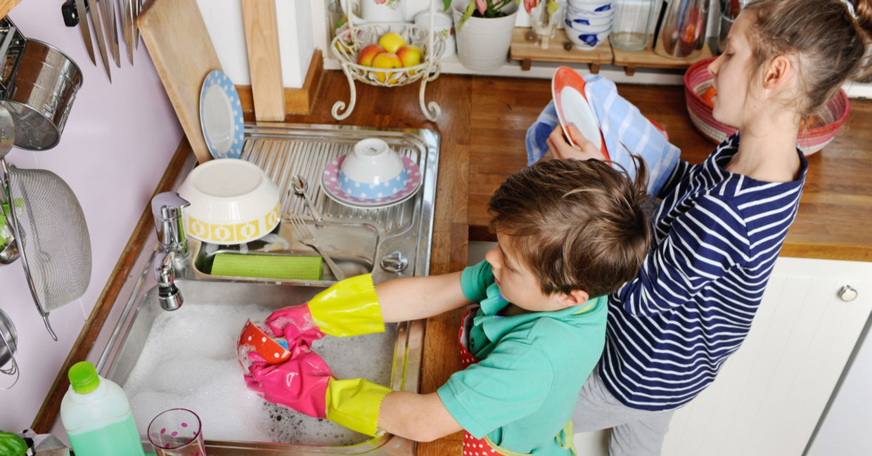 Two young children are washing dishes. Two young children are washing dishes.