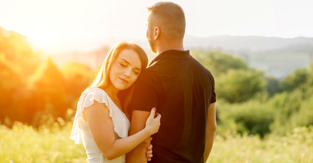 Couple hugging in the park at sunset. Couple hugging in the park at sunset.