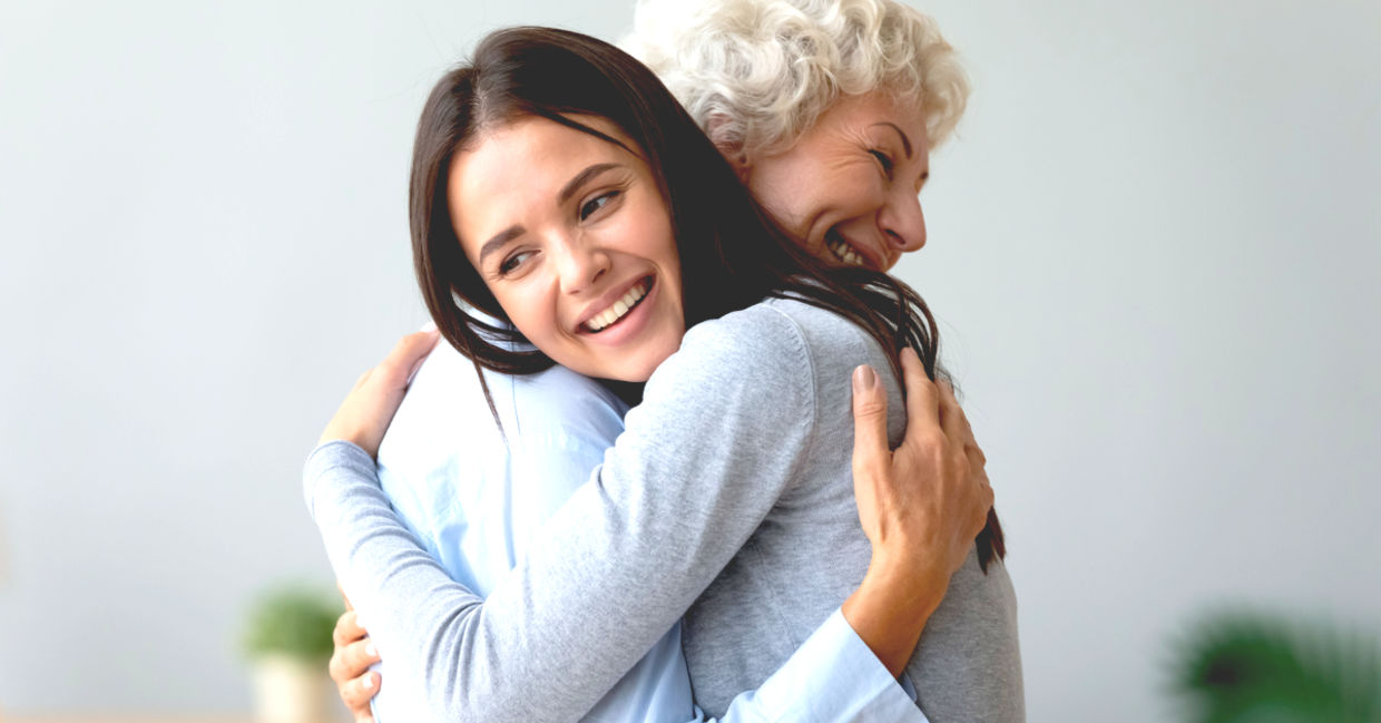 Young granddaughter hugging her grandmother. Young granddaughter hugging her grandmother.