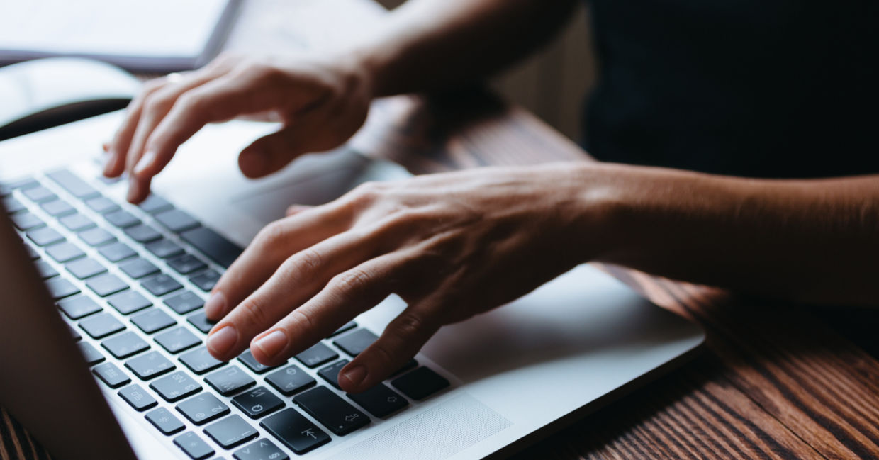 A woman typing. A woman typing.