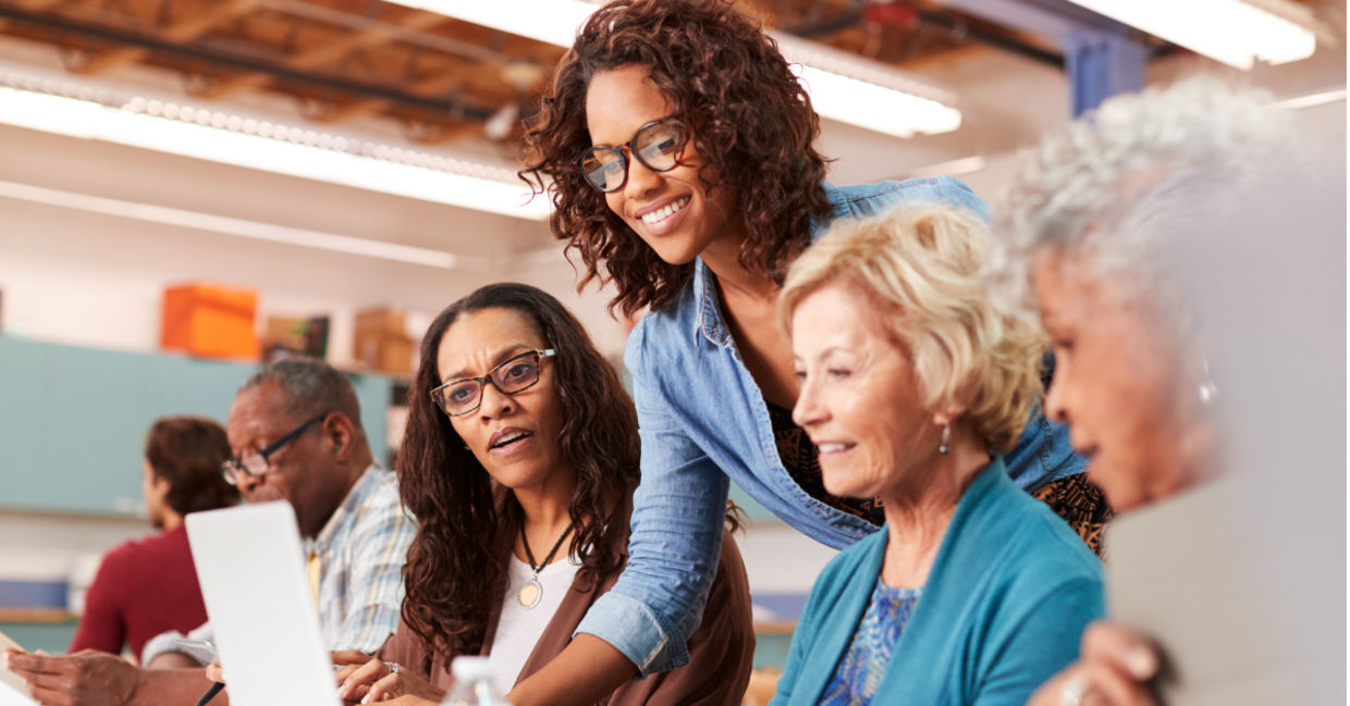 Retirees learning how to use a computer. Retirees learning how to use a computer.