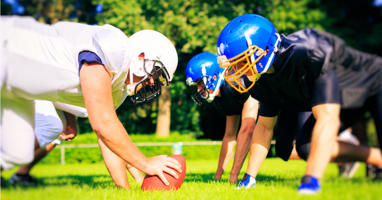 High school football players facing off. High school football players facing off.