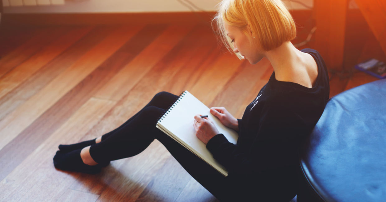 Woman sitting on wooden floor Woman sitting on wooden floor