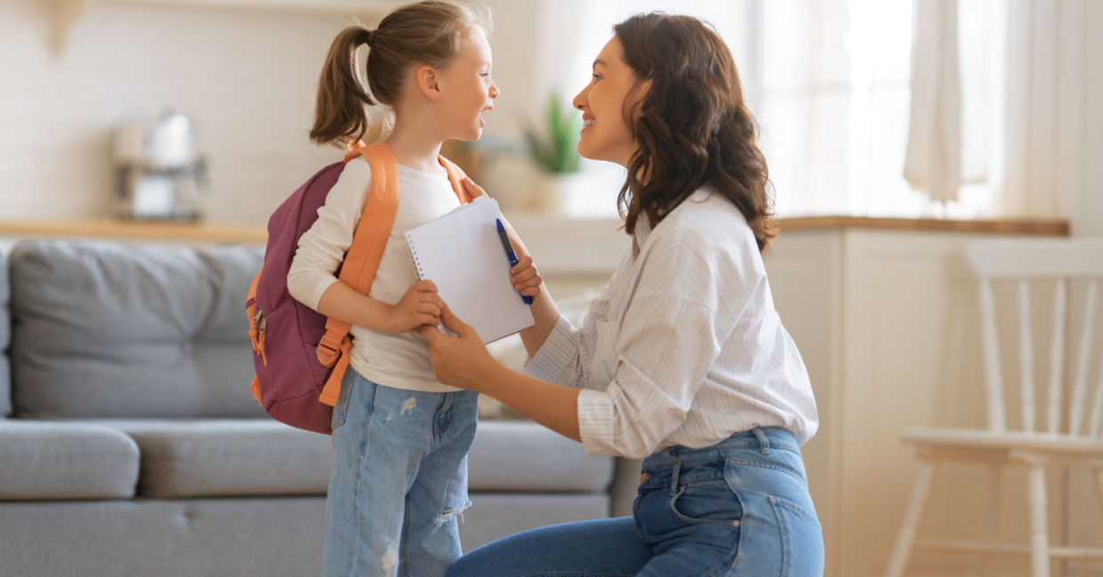 Mother and daughter with backpack and notebook Mother and daughter with backpack and notebook