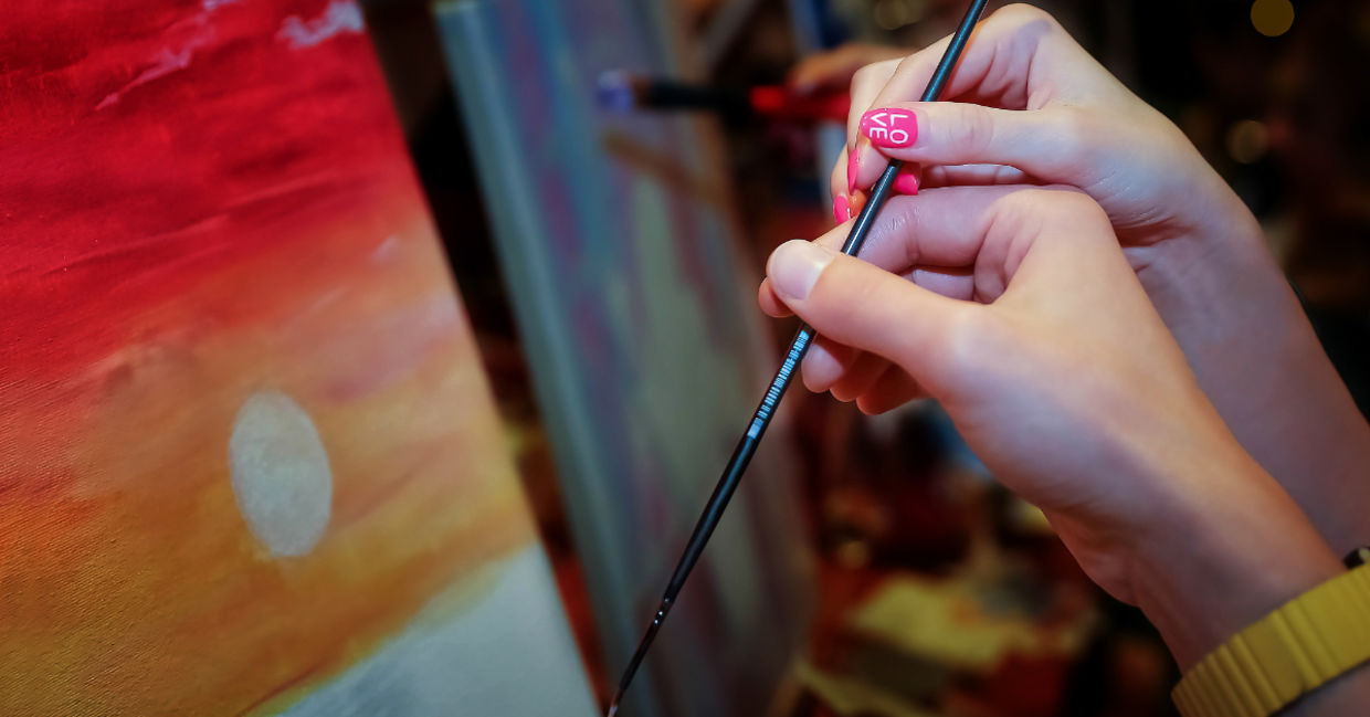 A couple holding a paint brush. A couple holding a paint brush.