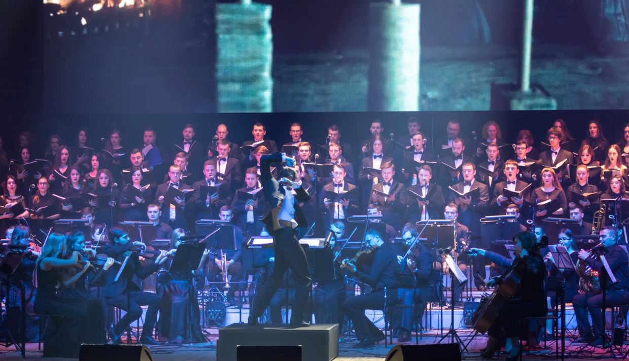 Choral group performs on stage Choral group performs on stage