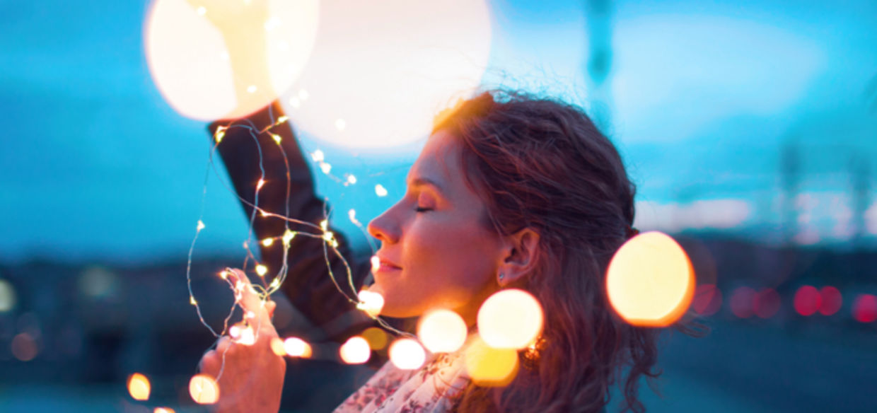 Woman holding fairy lights Woman holding fairy lights