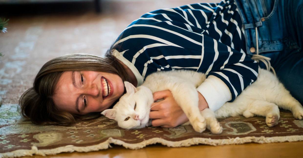 Girl relaxing to the sounds of a purring cat. Girl relaxing to the sounds of a purring cat.