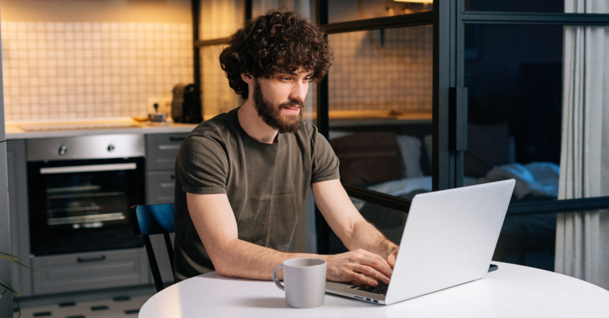 A young man typing on a laptop. A young man typing on a laptop.