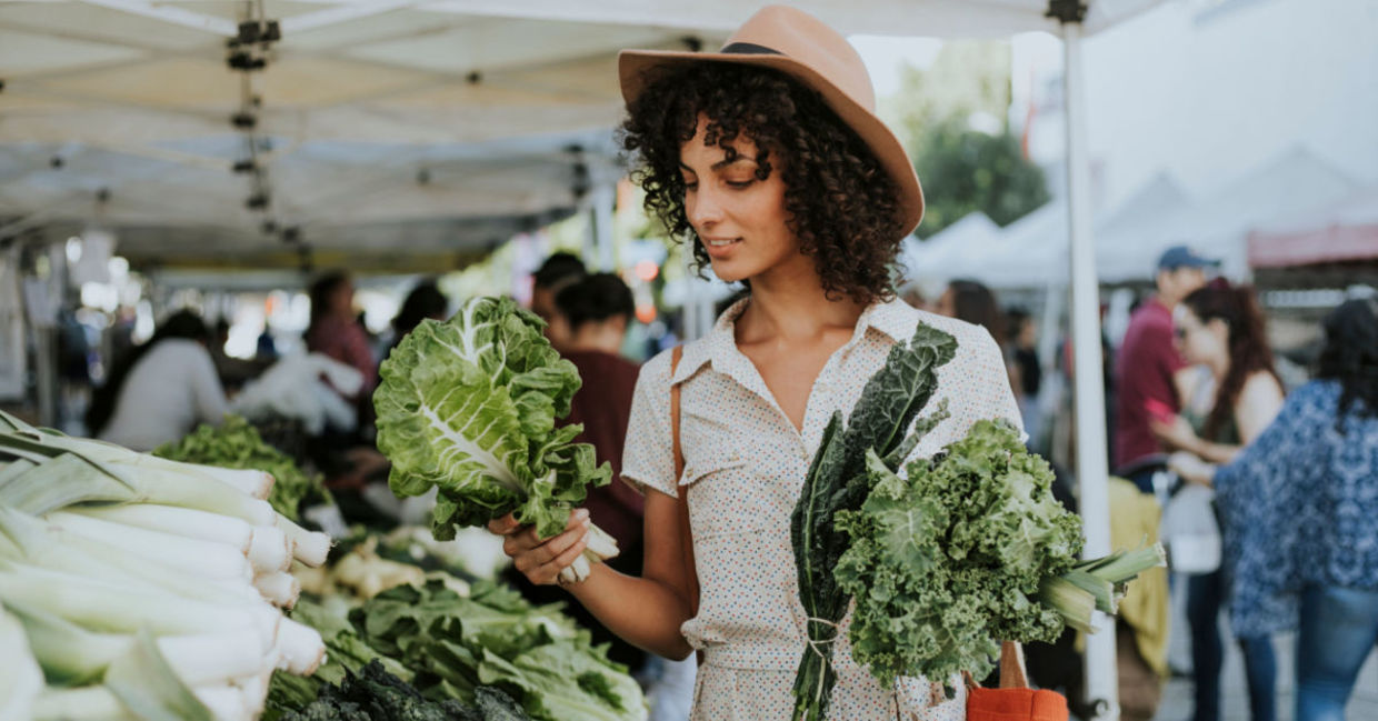 Woman buying kale at a farmers’ market Woman buying kale at a farmers’ market
