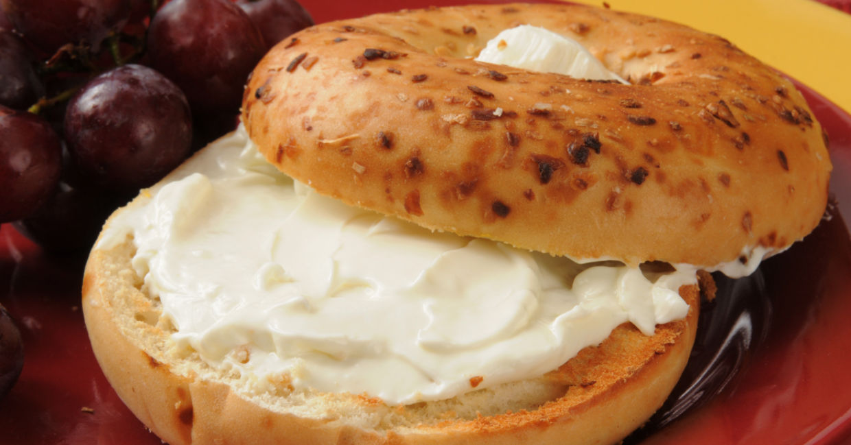 An onion bagel with a smear of plant-based vegan cream cheese. An onion bagel with a smear of plant-based vegan cream cheese.