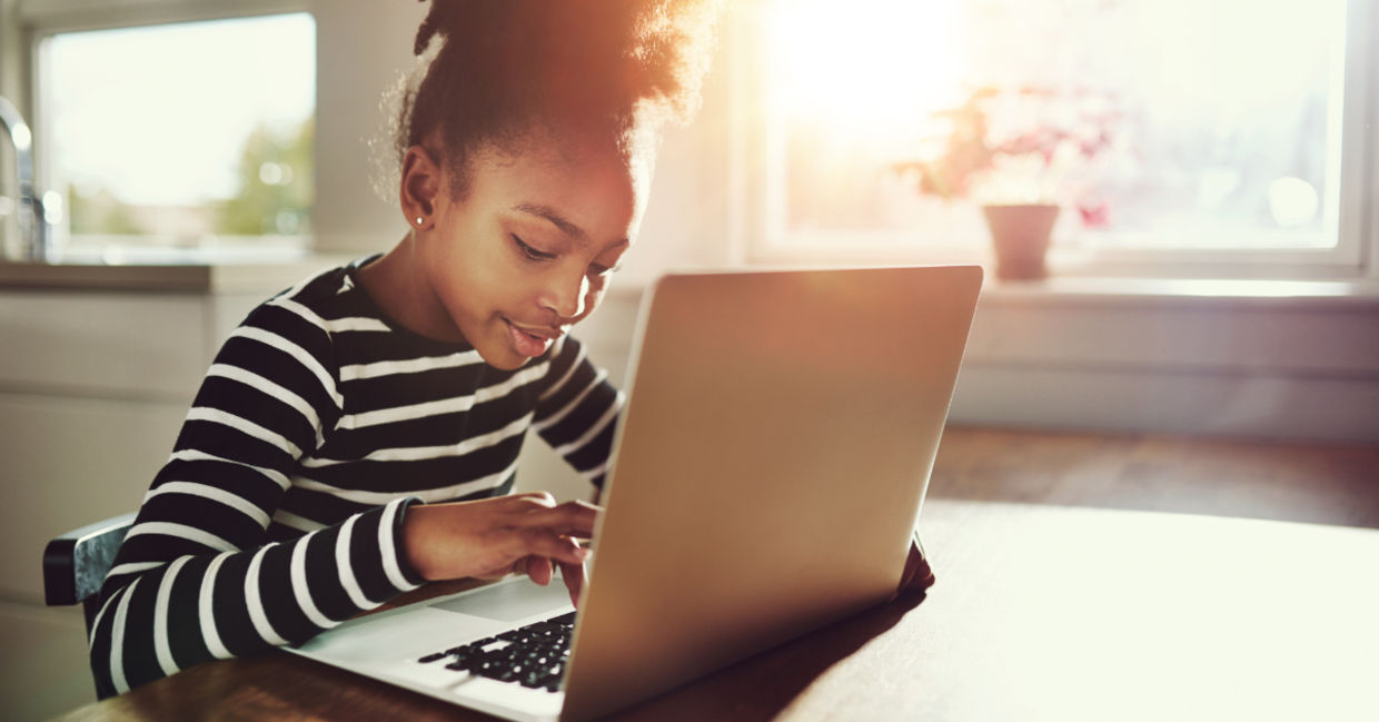 A young girl using a laptop. A young girl using a laptop.