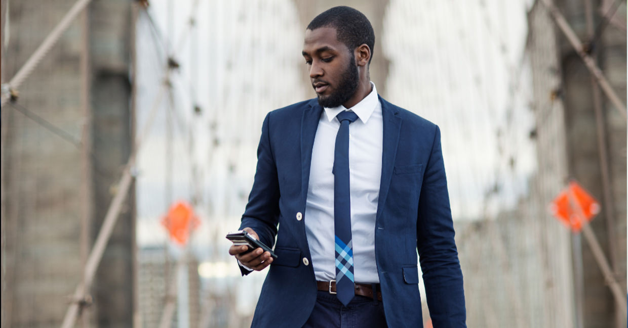 Young businessman using mobile phone on Brooklyn Bridge, New York City. Young businessman using mobile phone on Brooklyn Bridge, New York City.