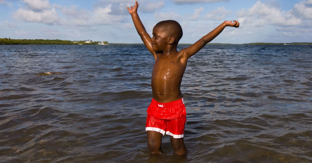 a boy's first time in the ocean. a boy's first time in the ocean.