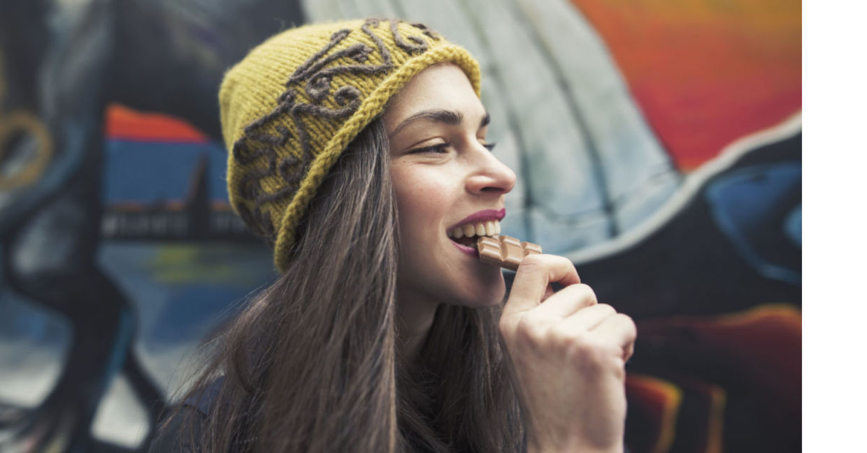 Woman enjoying a chocolate bar. Woman enjoying a chocolate bar.
