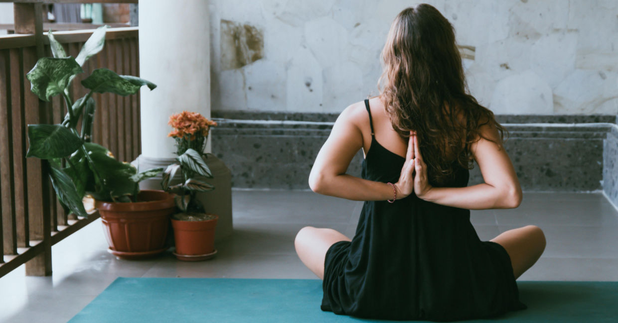 Woman doing the reversed prayer yoga pose. Woman doing the reversed prayer yoga pose.
