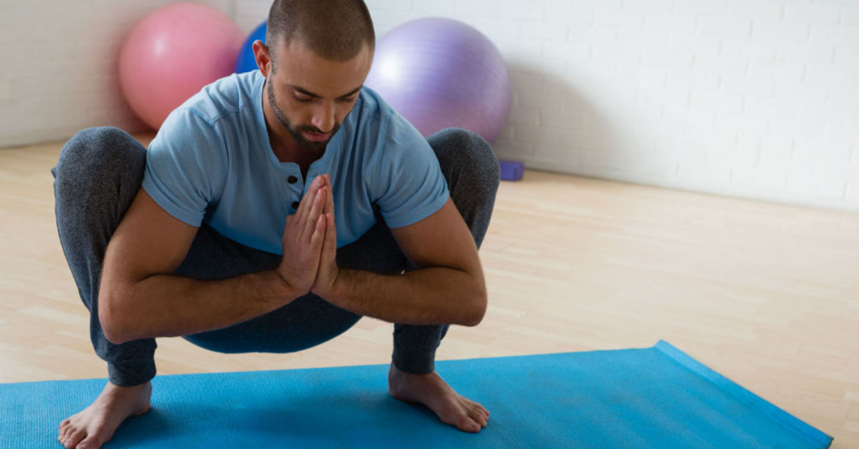 Man in the yogi squat pose. Man in the yogi squat pose.