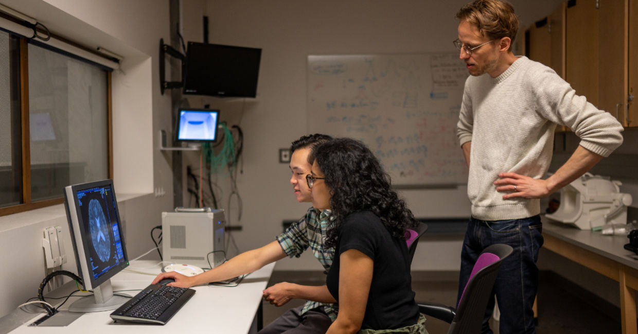 researchers looking at brain scans. researchers looking at brain scans.