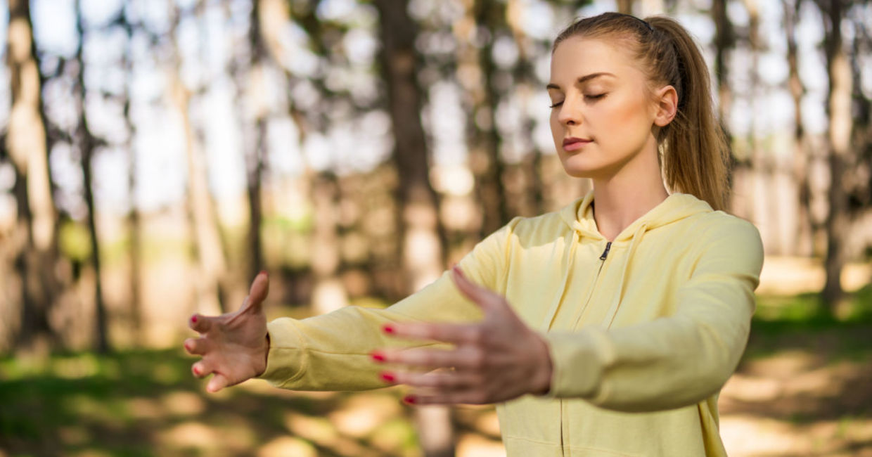Practicing tai chi in a forest. Practicing tai chi in a forest.