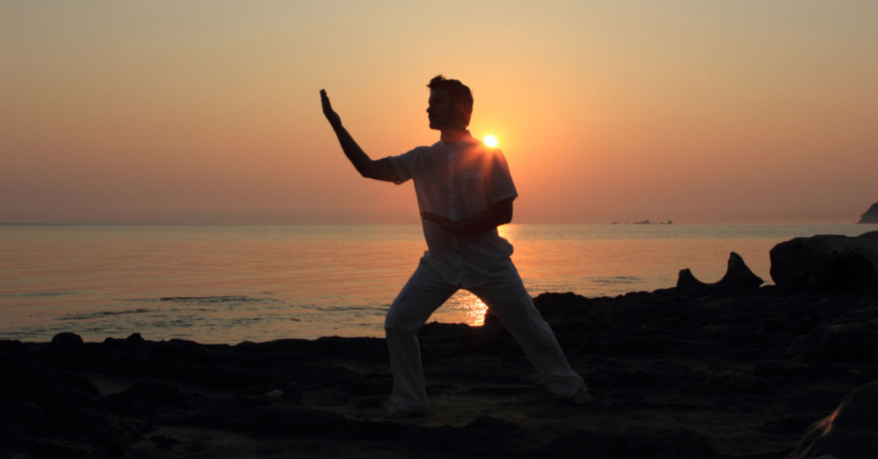 Man doing tai chi at sunrise. Man doing tai chi at sunrise.