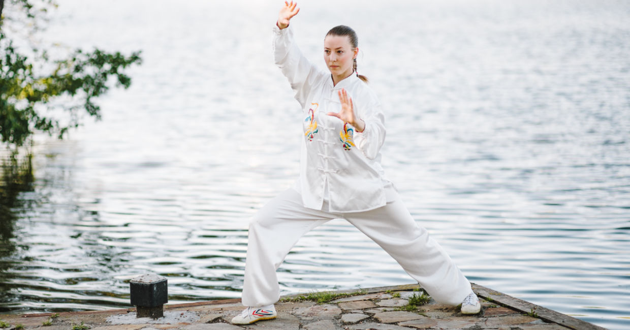 Tai chi in a garden with flowing water. Tai chi in a garden with flowing water.