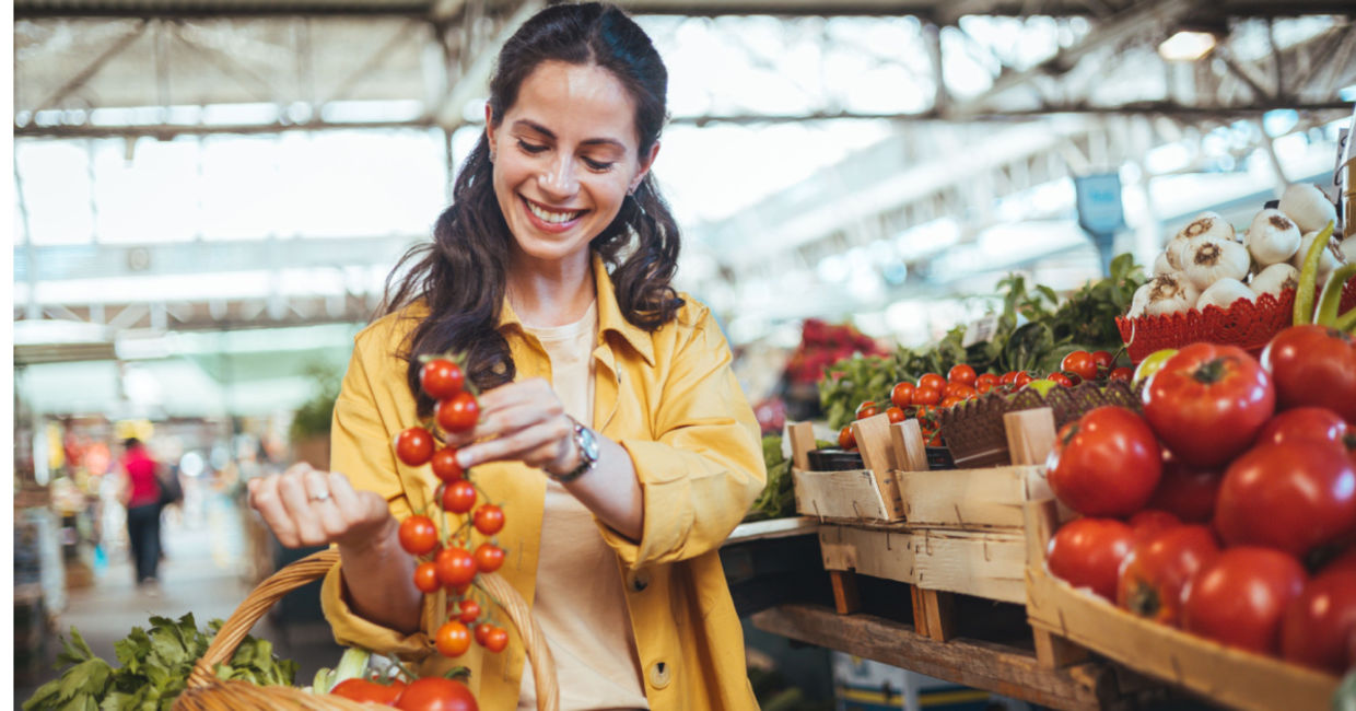 Buying tomatoes at a farmers market. Buying tomatoes at a farmers market.