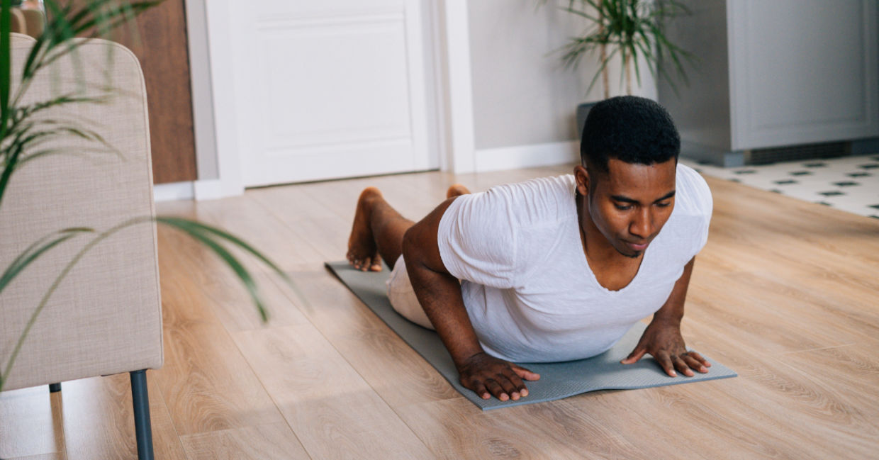 Man doing burpees at home. Man doing burpees at home.