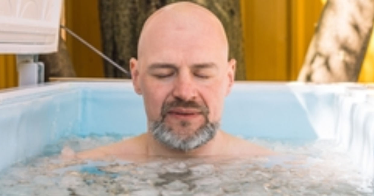 Man taking an ice bath. Man taking an ice bath.