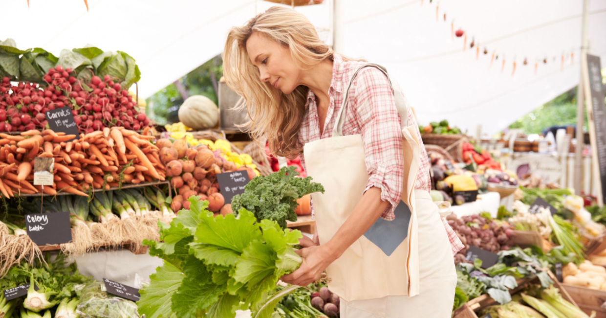 Woman buying vegetables at a farmer's market. Woman buying vegetables at a farmer's market.