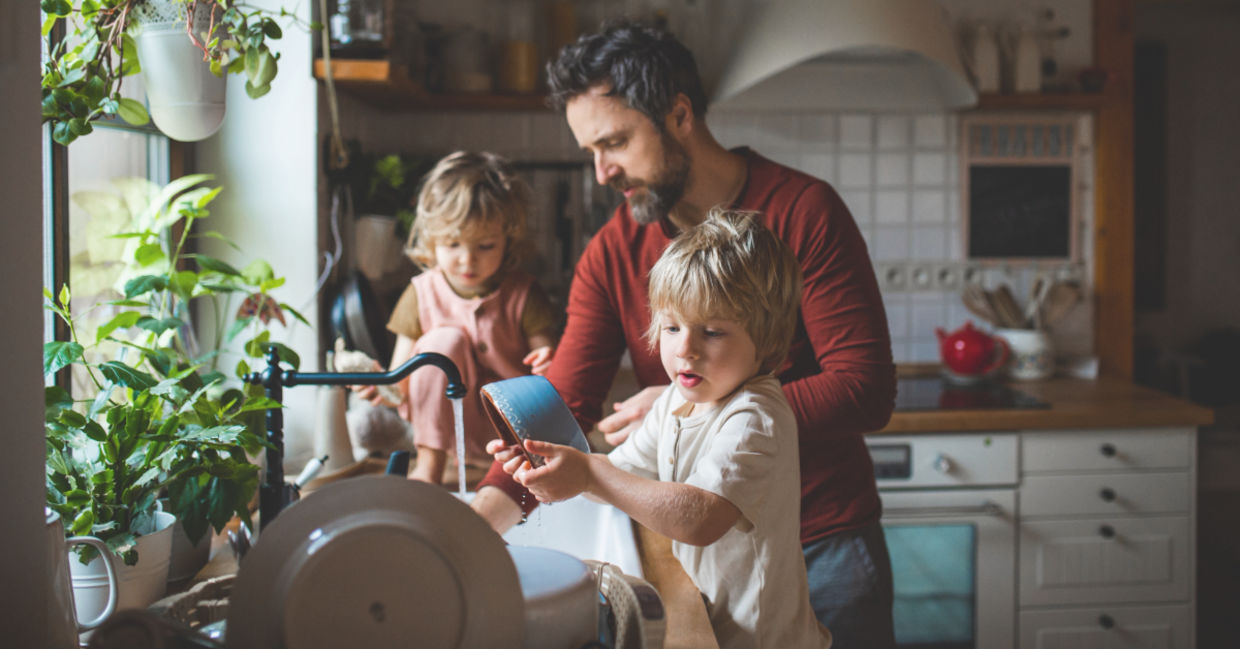 Father and sons washing dishes. Father and sons washing dishes.