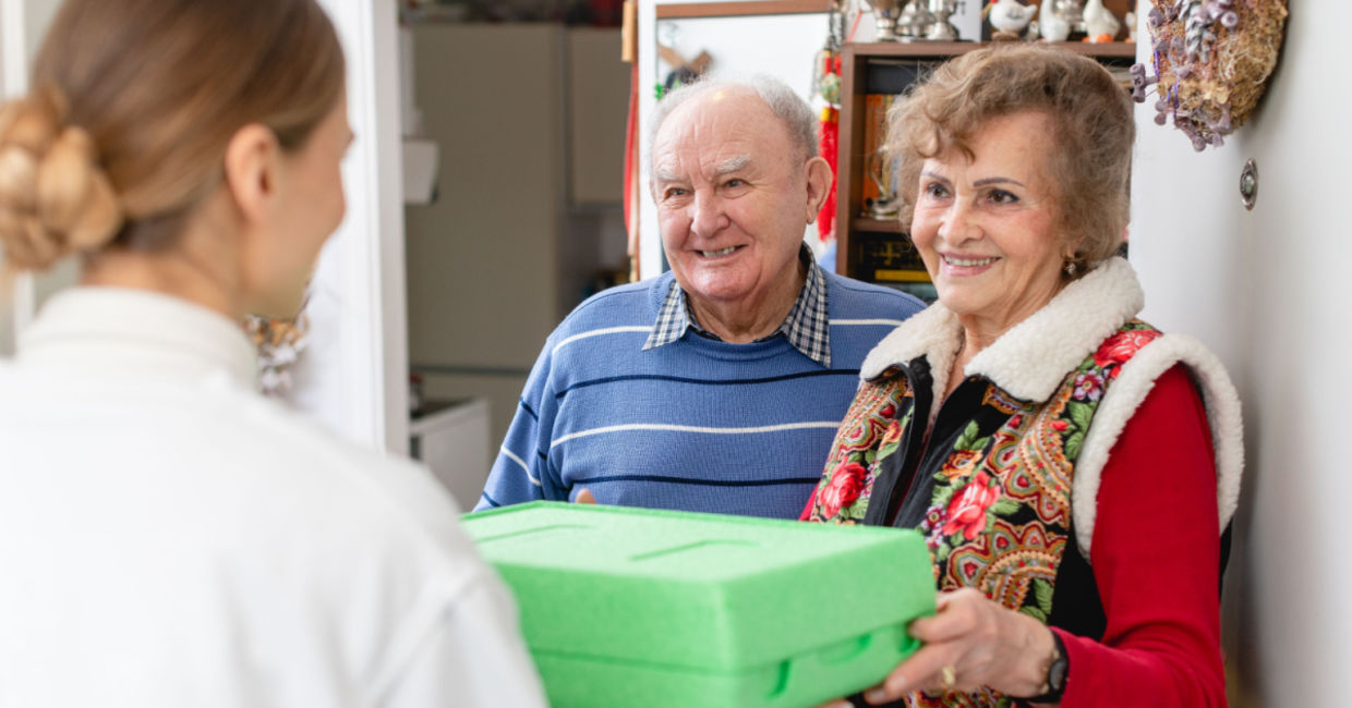 Delivering a meals on wheels Thanksgiving dinner. Delivering a meals on wheels Thanksgiving dinner.