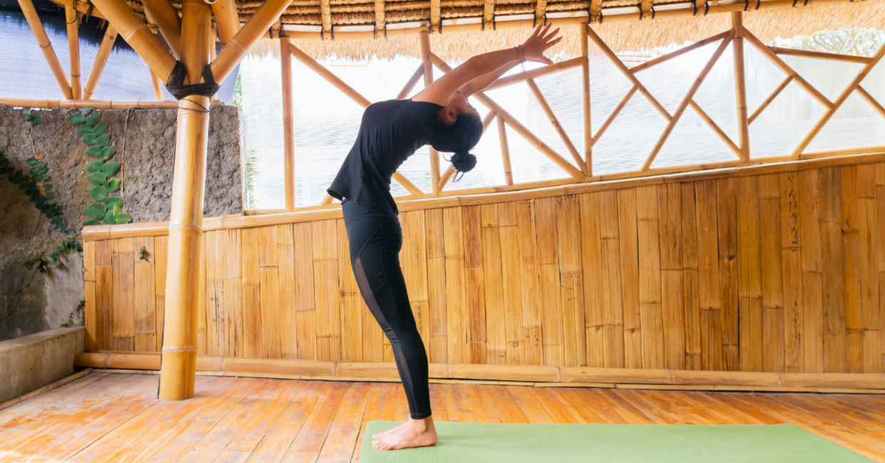 Woman in the crescent moon pose. Woman in the crescent moon pose.