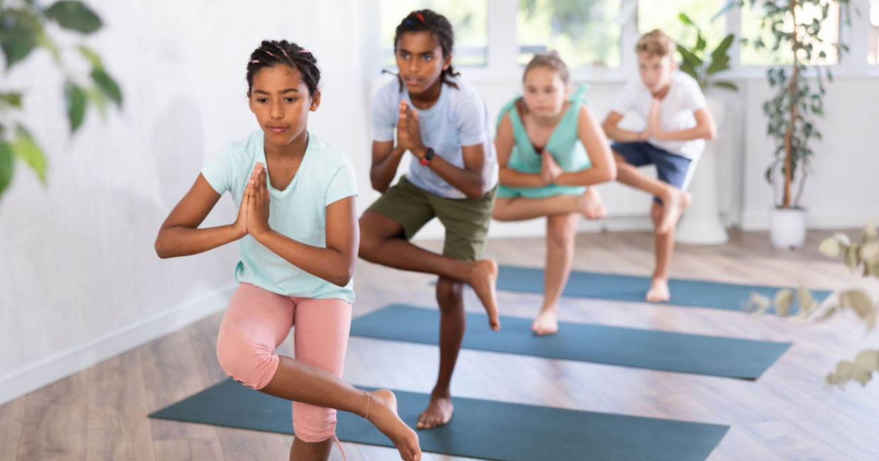 Teens learning the eagle pose. Teens learning the eagle pose.