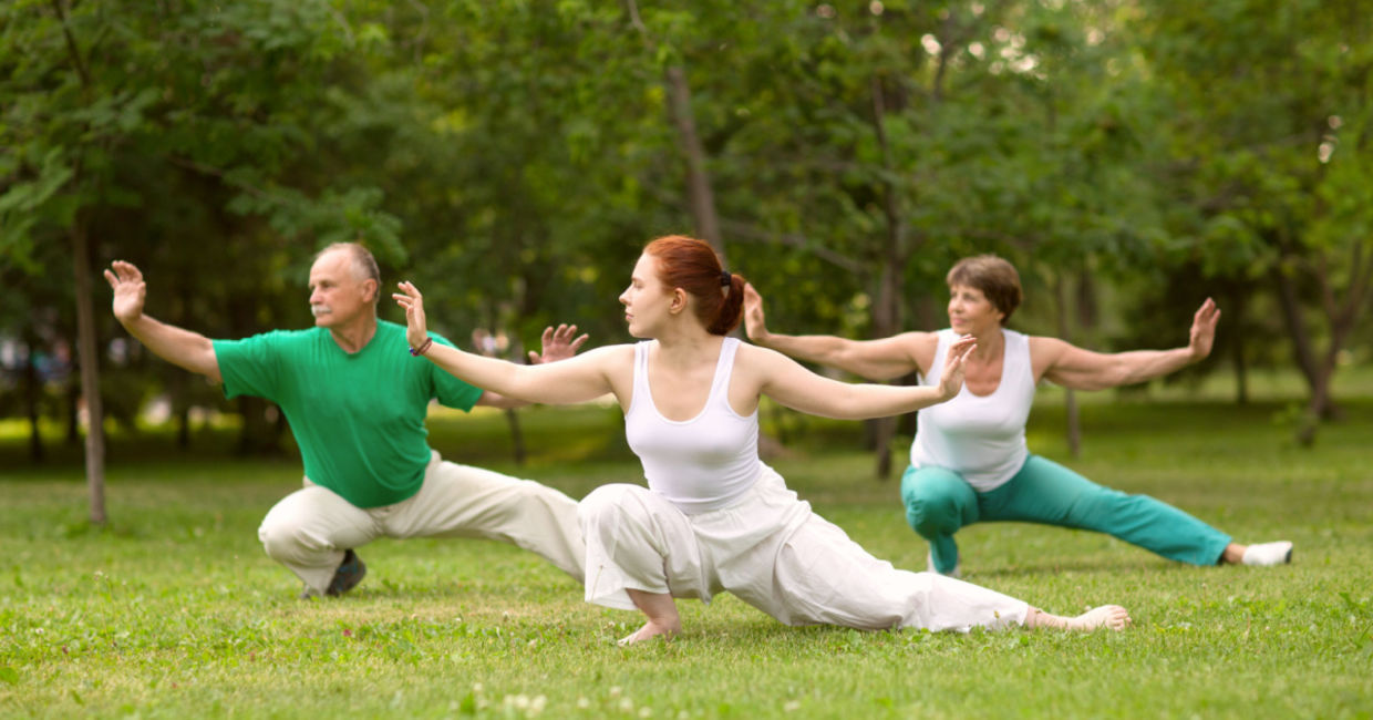 Practicing qigong in a park. Practicing qigong in a park.