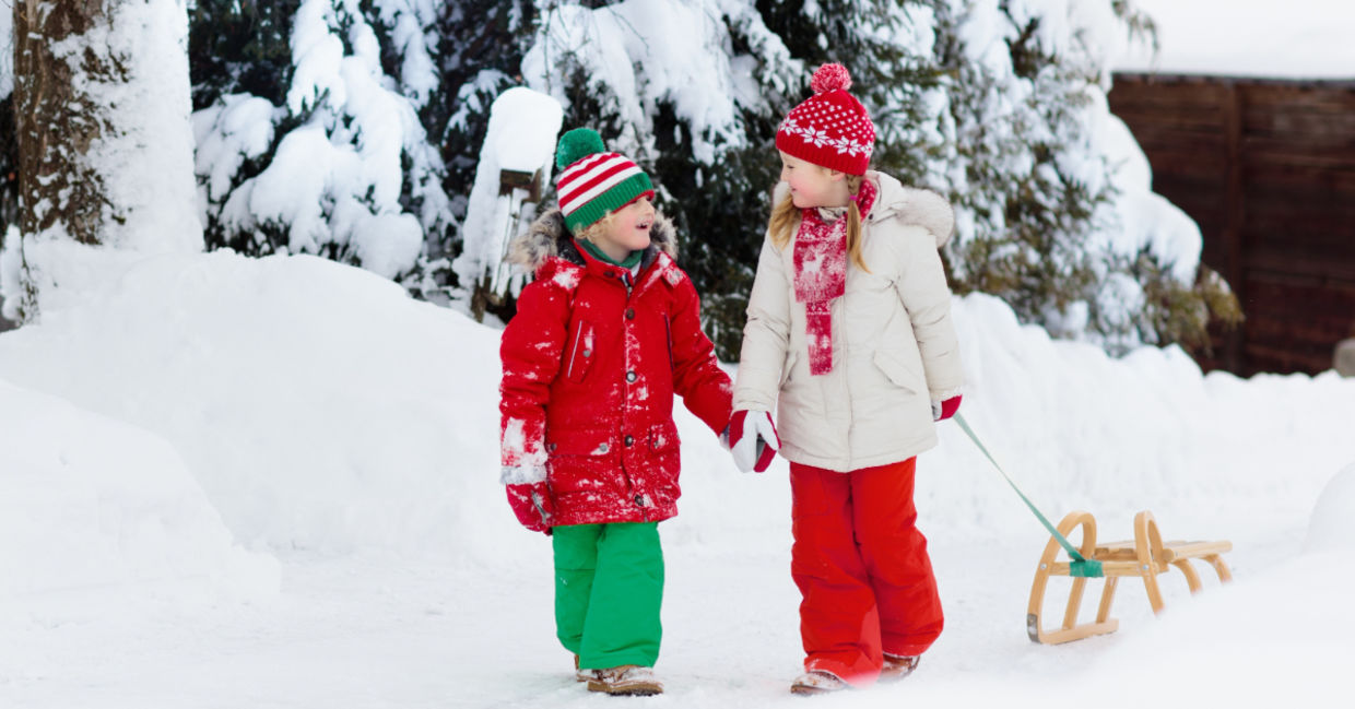 Child going sledding in the snow. Child going sledding in the snow.