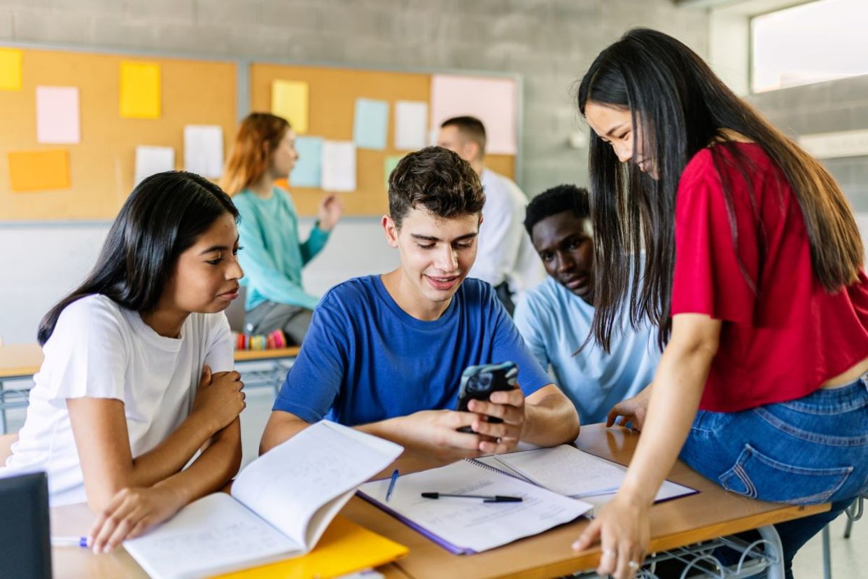 Teens using cellphones during school. Teens using cellphones during school.
