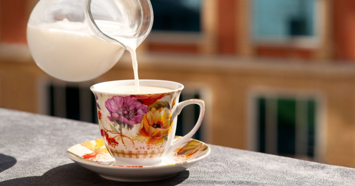 Pouring nondairy milk into a cup of tea. Pouring nondairy milk into a cup of tea.