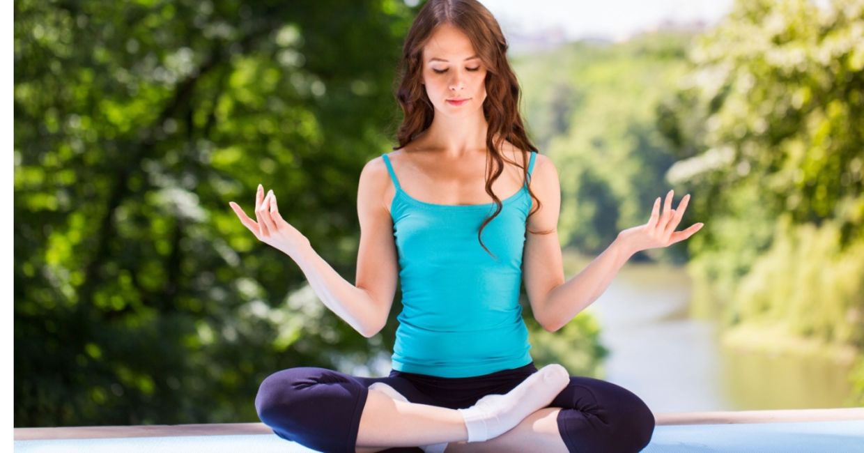 Doing yoga in a park. Doing yoga in a park.