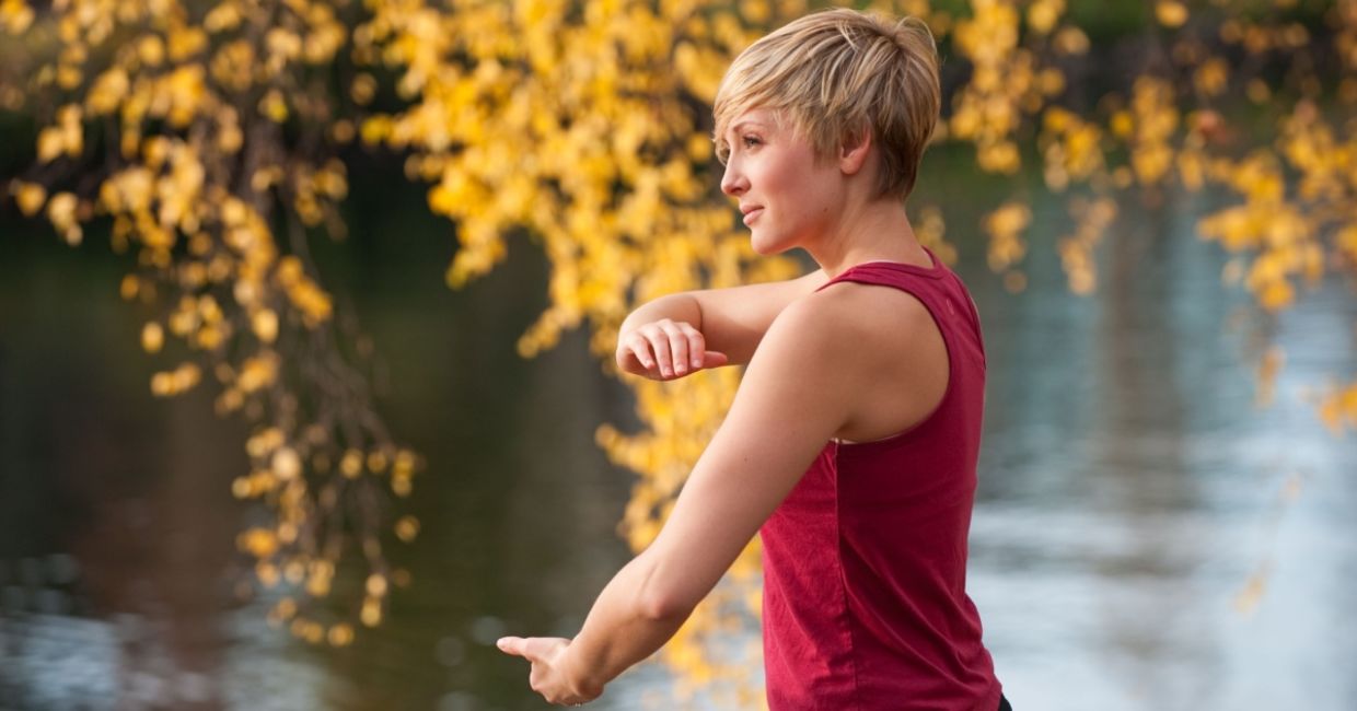 Practicing tai chi near the water. Practicing tai chi near the water.