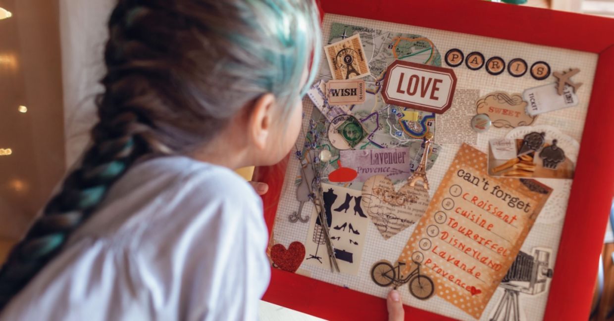 A vision board idea for travel to France is made by a woman who wants to manifest travel. A vision board idea for travel to France is made by a woman who wants to manifest travel.