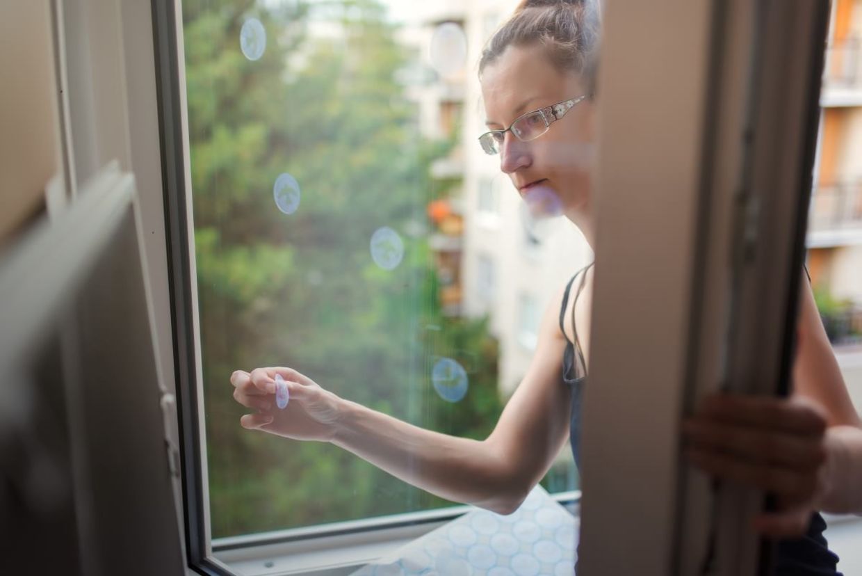 Placing reflective decals on a window. Placing reflective decals on a window.