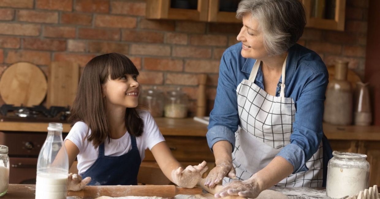 Grandmother teaching her granddaughter how to bake. Grandmother teaching her granddaughter how to bake.