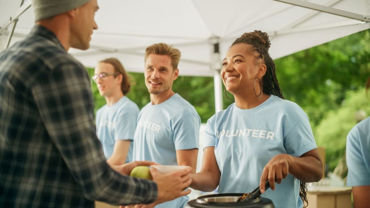 Volunteers feeding hungry people. Volunteers feeding hungry people.