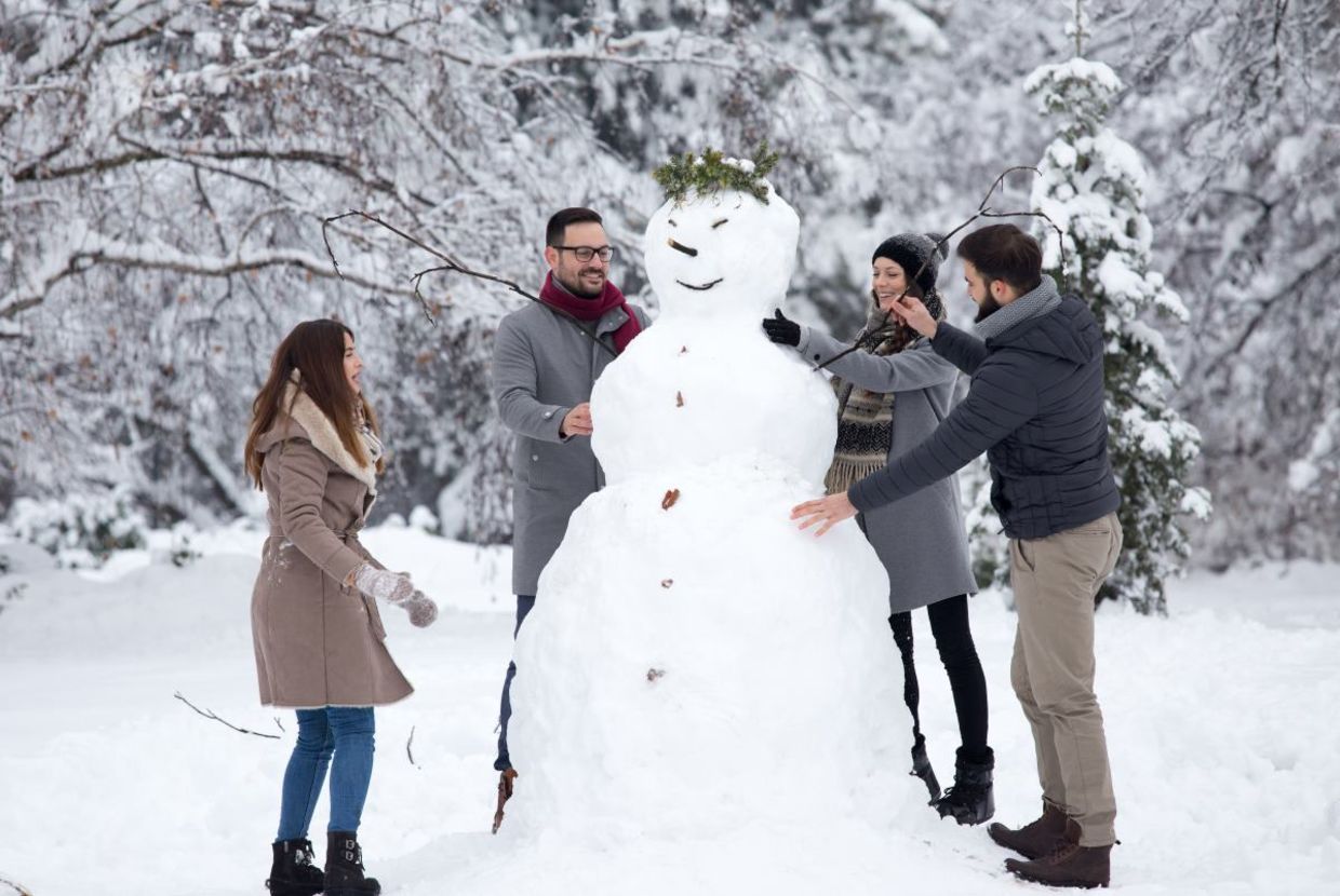 Friends building a snowman. Friends building a snowman.