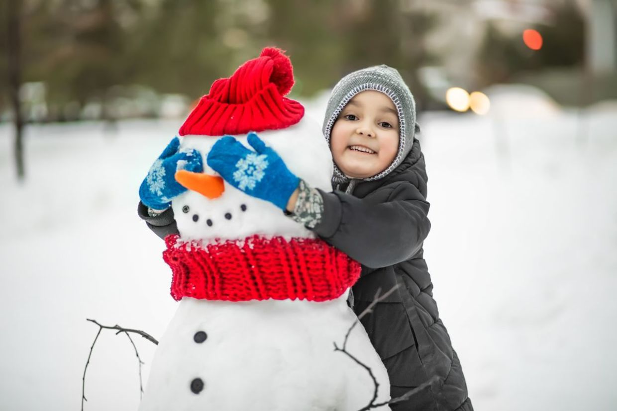 Adding the finishing touches to a snowman. Adding the finishing touches to a snowman.