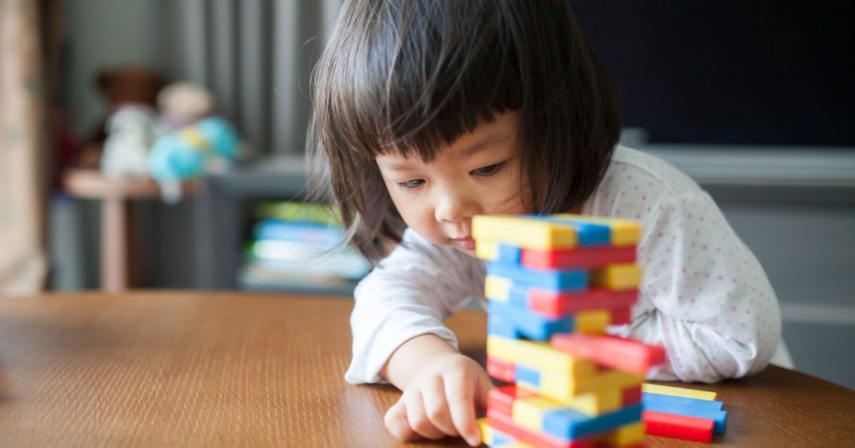 Little preschooler playing with wooden blocks. Little preschooler playing with wooden blocks.