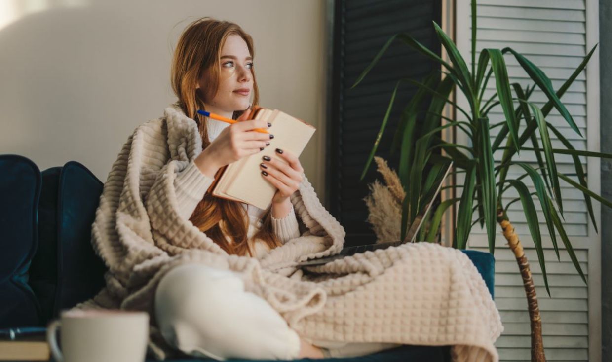 A woman writing in her journal. A woman writing in her journal.