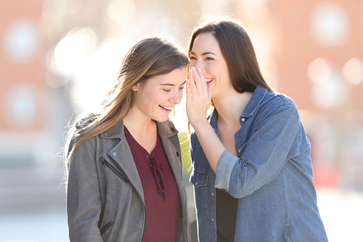 Two friends sharing good news.
