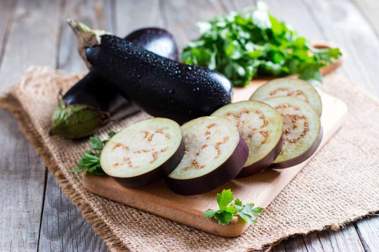 Slicing an aubergine. Slicing an aubergine.