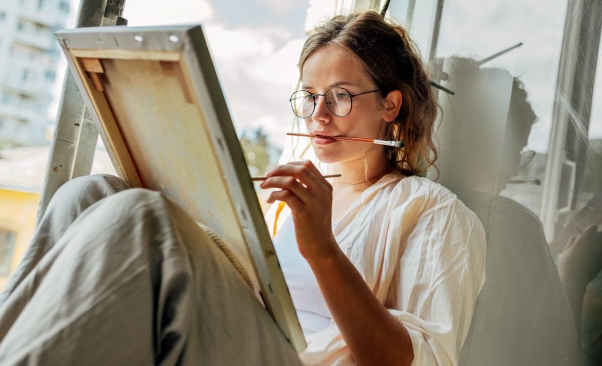 Young mom taking some me time to paint.